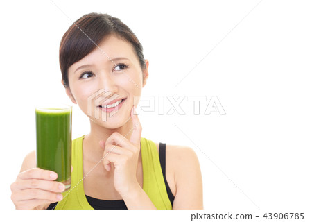 A woman drinking vegetable juice A woman drinking vegetable juice 43906785