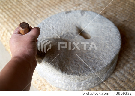 A hand turning a stone A hand turning a stone 43909352