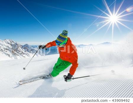 Skier skiing downhill in high mountains Skier skiing downhill in high mountains 43909492