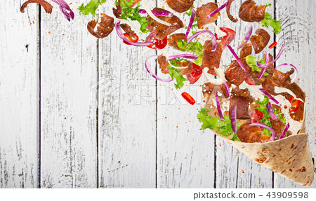 Kebab sandwich with flying ingredients. Kebab sandwich with flying ingredients. 43909598