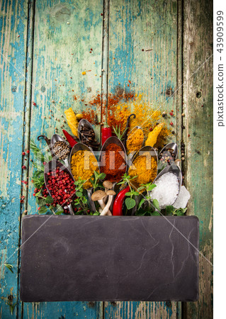 Various colorful spices on wooden table 43909599