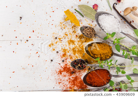 Various colorful spices on wooden table Various colorful spices on wooden table 43909609