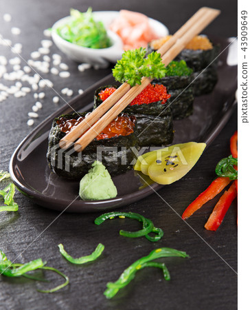 Japanese sushi set on a rustic dark background. 43909649