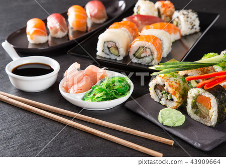 Japanese sushi set on a rustic dark background. Japanese sushi set on a rustic dark background. 43909664
