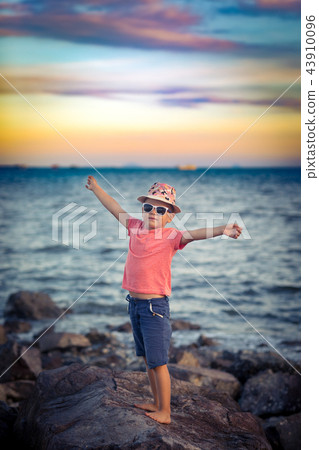 Little boy on the rock 43910096