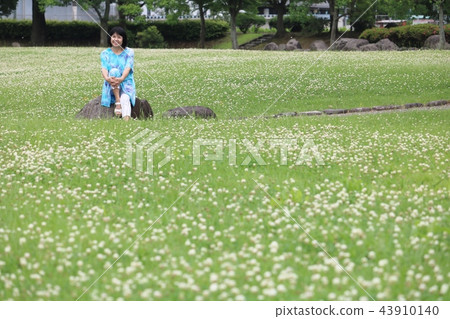 Bright mature woman shines in green park 43910140