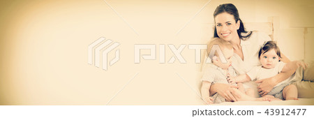 Cheerful mother with cute babies 43912477