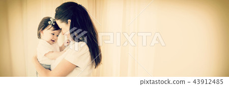 Happy mother carrying cute baby girl 43912485