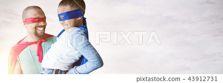 Composite image of father and son pretending to be superhero Composite image of father and son pretending to be superhero 43912731