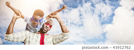 Composite image of father and son pretending to be superhero 43912762