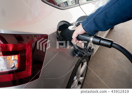 Closeup of man pumping diesel fuel. Closeup of man pumping diesel fuel. 43912819