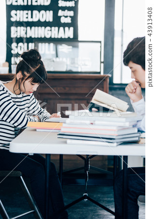 Two people studying in a cafe 43913408