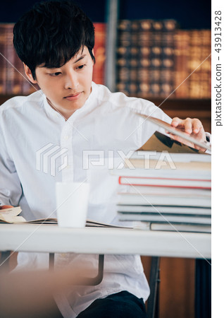 Men writing a report in the library Men writing a report in the library 43913428