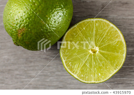 Table top view on green lime cut in half Table top view on green lime cut in half 43915970
