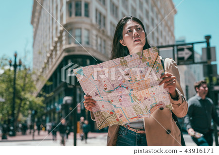 girl holding guide map and looking lost girl holding guide map and looking lost 43916171