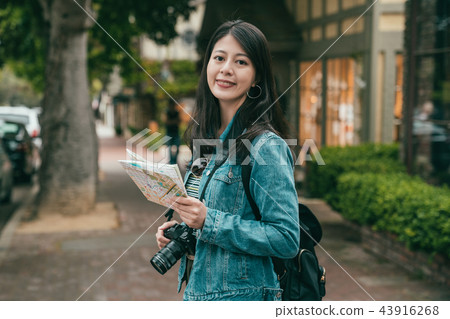 woman smiling joyfully to camera and sighseeing 43916268