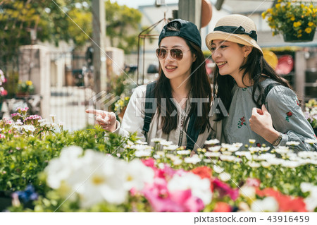 women hanging out in a florist happily 43916459