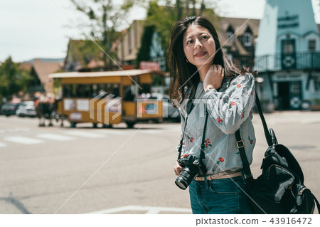 beautiful woman taking photos while visiting 43916472