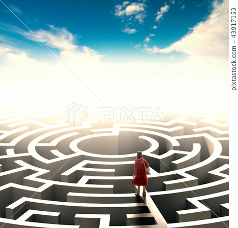 Miniature people standing over a maze.  43917153
