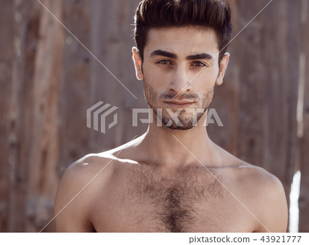 Handsome topless young man outdoors 43921777