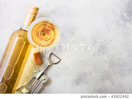 Bottle and glasses of white wine with cork  43922492