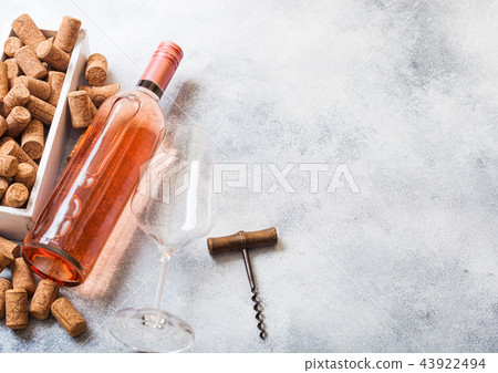 Bottle and glasses of pink rose wine with box  43922494
