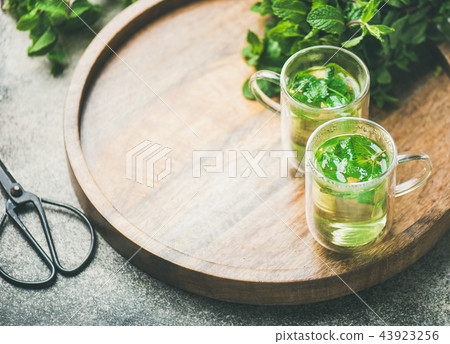 Hot herbal mint tea in glass mugs, copy space Hot herbal mint tea in glass mugs, copy space 43923256