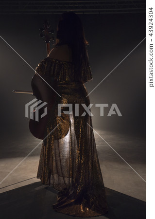 The cellist performs on stage. The cellist performs on stage. 43924304