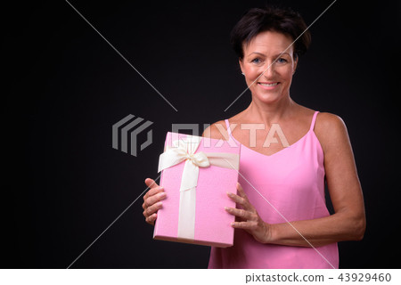 Mature Beautiful Woman With Short Hair Against Stock Photo