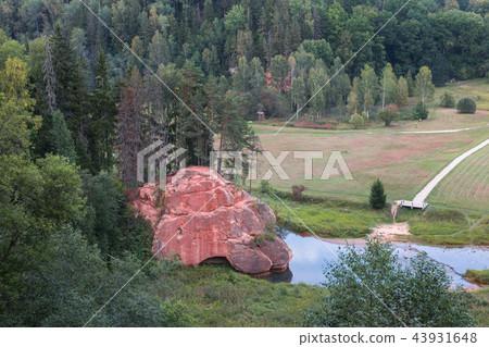 Summer landscape and red stone cliff of Amata river, Latvia, Europe. 43931648