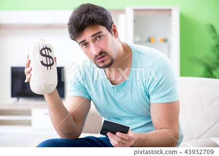 Young man struggling with personal finance and bills Young man struggling with personal finance and bills 43932709