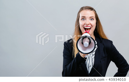 Young woman with a megaphone Young woman with a megaphone 43934010