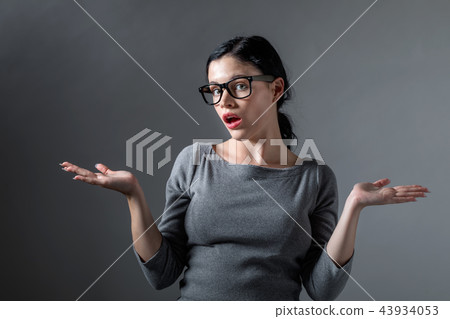 Young woman shrugging Young woman shrugging 43934053