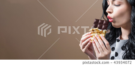Young woman holding chocolate Young woman holding chocolate 43934072