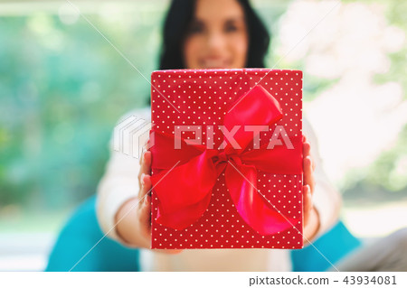 Young woman with a gift box 43934081