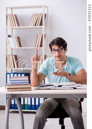 Young handsome student preparing for school exams Young handsome student preparing for school exams 43935323