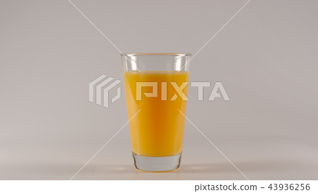 Full glass with orange juice on white background 43936256