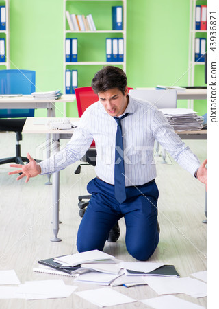 Frustrated businessman stressed from excessive work Frustrated businessman stressed from excessive work 43936871