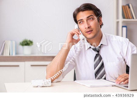 Young call center operator speaking on phone Young call center operator speaking on phone 43936929
