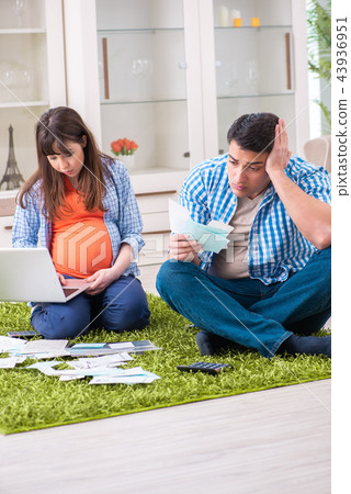 Young family in budget planning concept 43936951