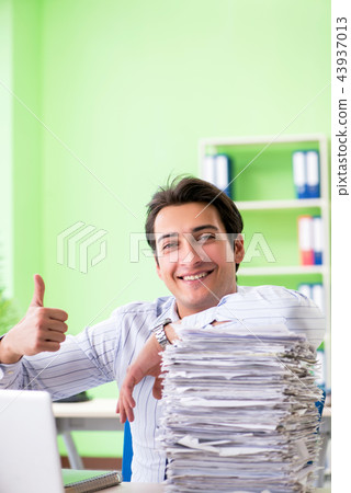 Businessman having problems with paperwork and workload Businessman having problems with paperwork and workload 43937013