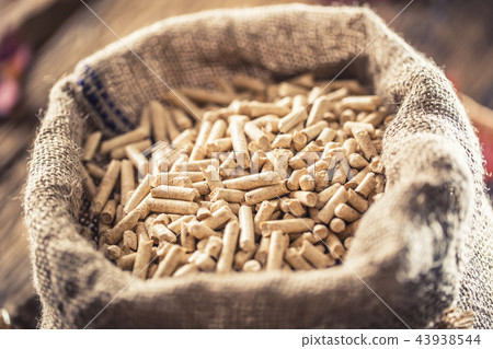 Wooden pressed pellets from biomass in old sack Wooden pressed pellets from biomass in old sack 43938544
