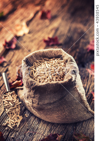Wooden pressed pellets from biomass in old sack 43938545