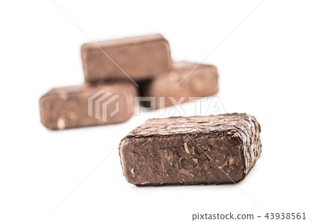 Wooden pressed briquettes from biomass on a white Wooden pressed briquettes from biomass on a white 43938561