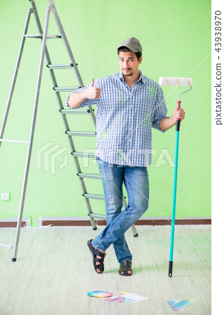 Young painter doing renovation at home Young painter doing renovation at home 43938970