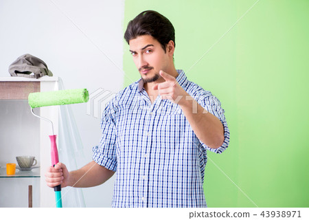 Young painter doing renovation at home Young painter doing renovation at home 43938971