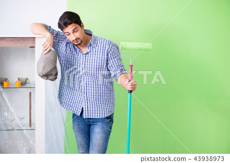 Young painter doing renovation at home Young painter doing renovation at home 43938973