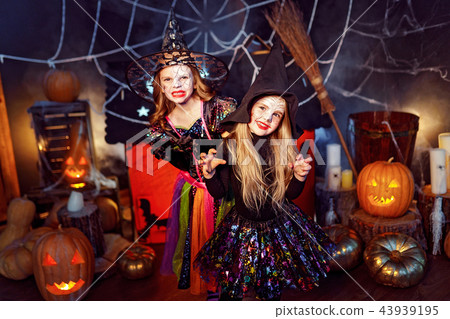 Two cute funny sisters celebrate the holiday. Jolly children in carnival costumes ready for Two cute funny sisters celebrate the holiday. Jolly children in carnival costumes ready for 43939195