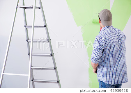 Young painter doing renovation at home Young painter doing renovation at home 43939428
