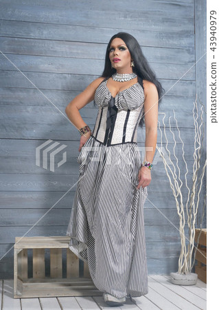 travesty-diva. The concept of a transvestite. Man-actor turns into a woman. he is posing for the 43940979